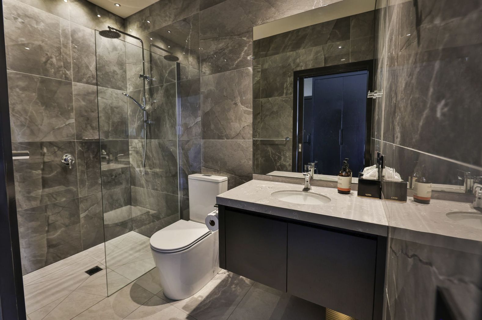 Ensuite bathroom with large-format stone-look tiles and a walk-in shower