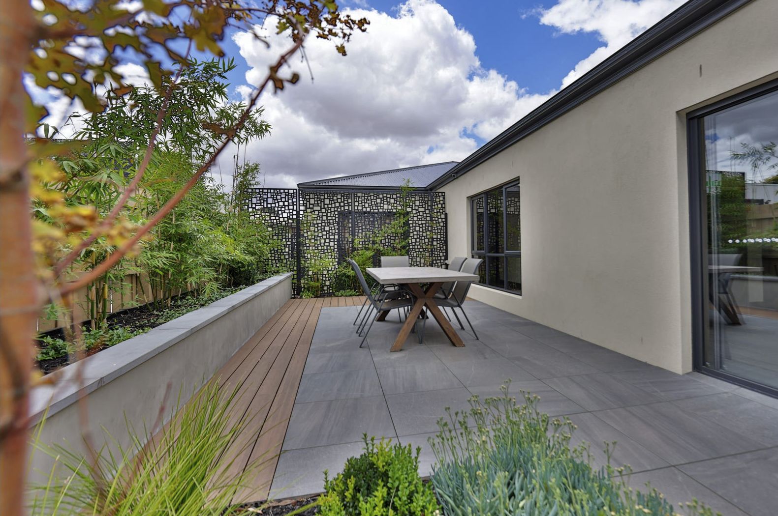Landscaped shared courtyard with outdoor dining at a Harmony property
