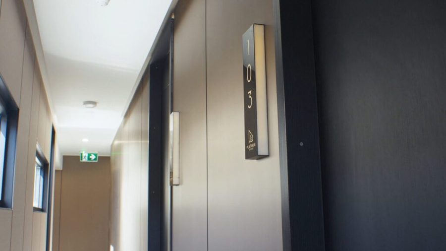 Corridor inside a completed co-living property with numbered suite doors