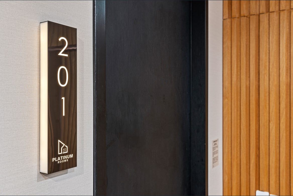 Illuminated Platinum Rooms door sign for suite 201