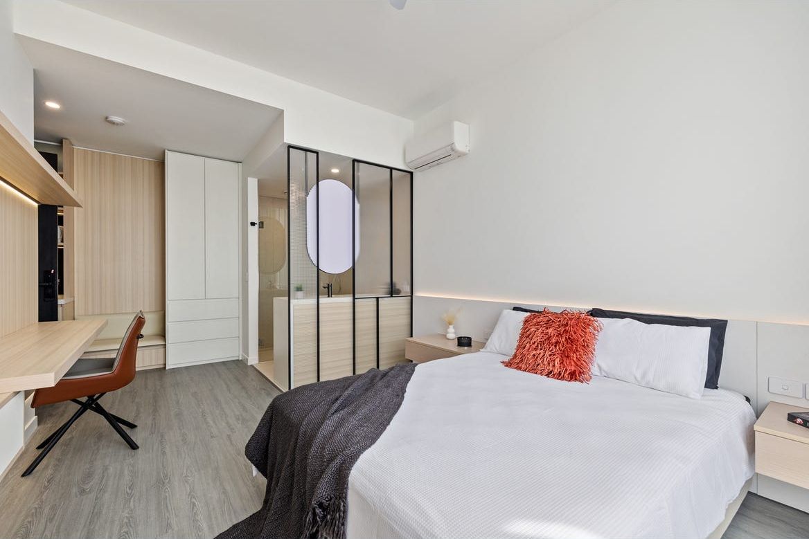 Harmony suite with a queen bed, built-in desk and glass-framed ensuite